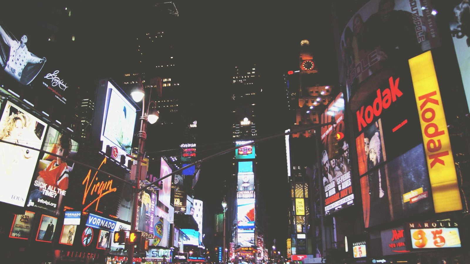 Illuminated signs crowding a street after midnight