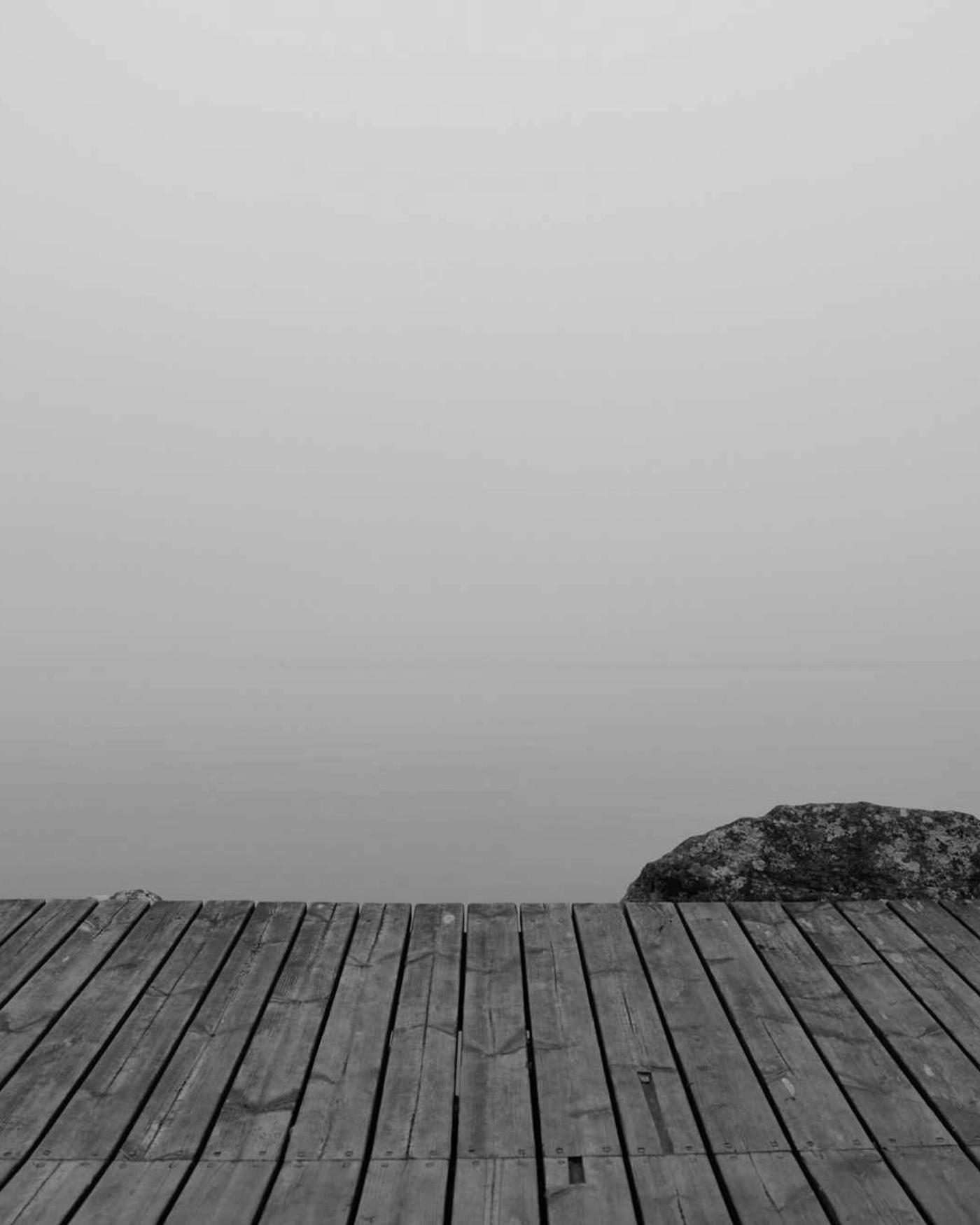 A wooden dock extending into still water
